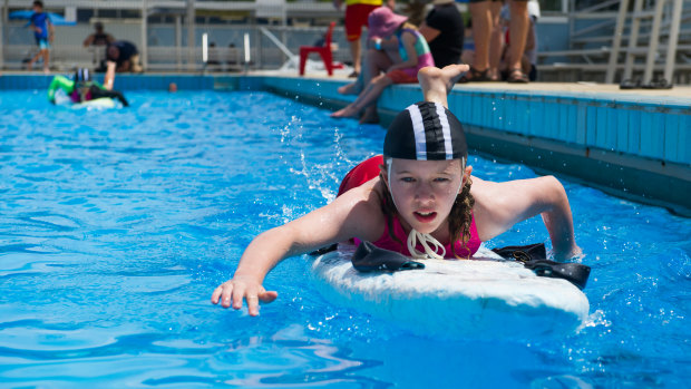 Finn Bolitho practices on the board at Canberra Olympic Pool.