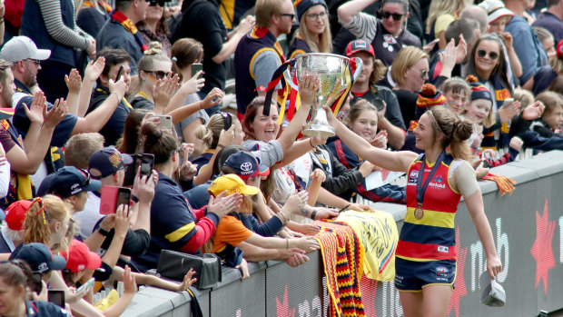 Leading by example: Crows player Jenna McCormick celebrates with fans after more than 53,000 packed the Adelaide Oval for the AFLW grand final.