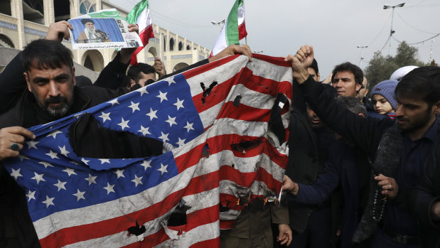 Protesters burn an American flag during a demonstration over the US killing of Qassem Soleimani in Tehran on Friday.