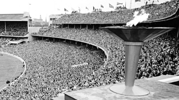 The Olympic flame slowly dies as it is extinguished to mark the closing of the 1956 Games.