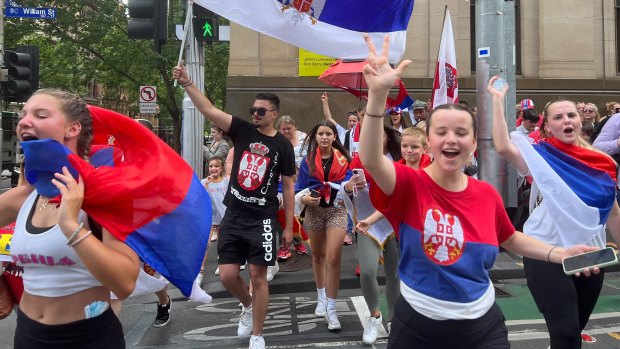 Serbian fans celebrate the news that Novak Djokovic had his visa cancellation overturned and was being released from detention.