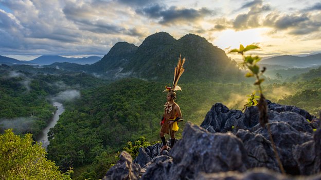 A Dayak tribesman from Kalimantan pauses at sunrise over Langara Hill in the Meratus Mountains. 