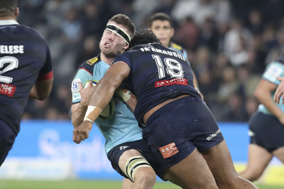 Max Douglas takes the full force of a high tackle from Pone Fa’amausili in a Super Rugby match.