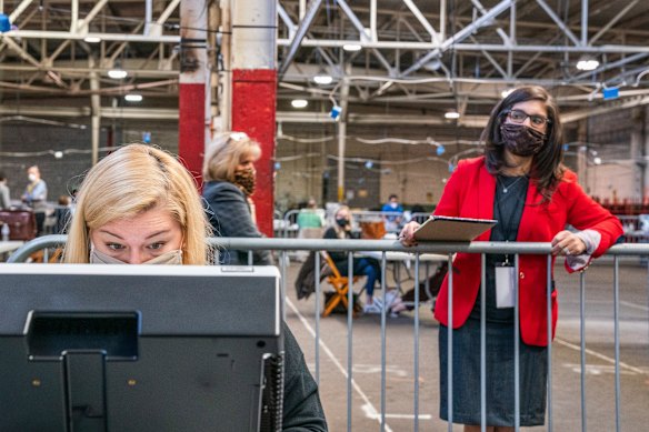 An election watcher observes an Allegheny County return board's counting of the remaining absentee and mail-in ballots. 