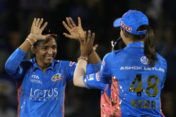 Mumbai Indians captain Harmanpreet Kaur, left, celebrates the dismissal of Meg Lanning during the Women’s Premier League Twenty20 cricket final.