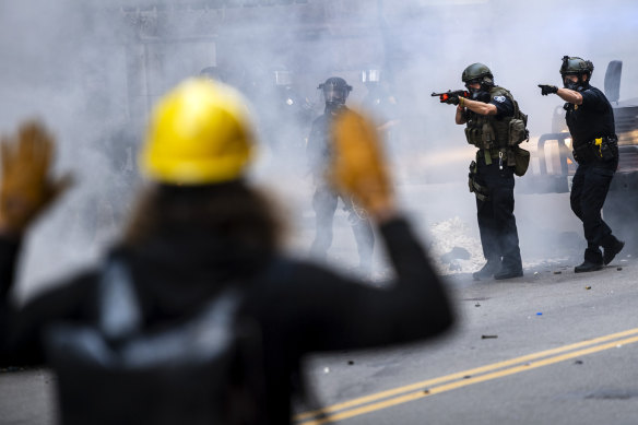 Police officers confront protesters during a  demonstration in downtown Pittsburgh.