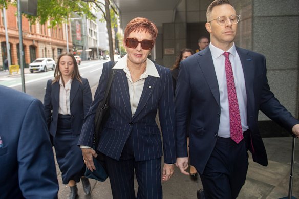 Former City of Parramatta chief executive Gail Connolly arrives at the Independent Commission Against Corruption on Thursday flanked by a legal team in flashes of pink.