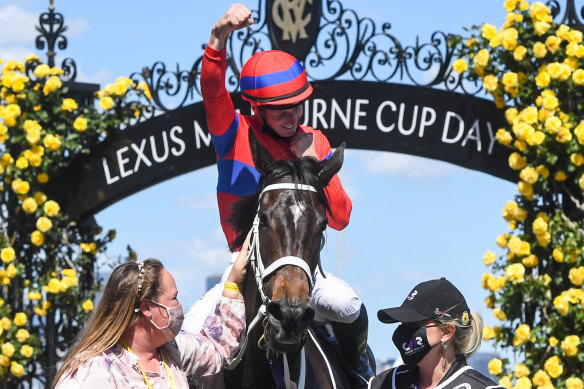 James McDonald raises his hand in triumph on return to the mounting yard at Flemington.