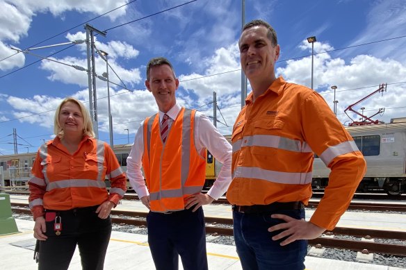 Transport Minister Mark Bailey (centre) concedes Queensland has not removed a single level crossing since 2014, while Victoria has removed 70. 
