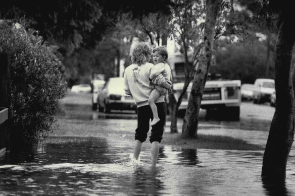 Thirty years ago this month - a mother carries her child down Torrens Street, Kurnell, February 4, 1990.