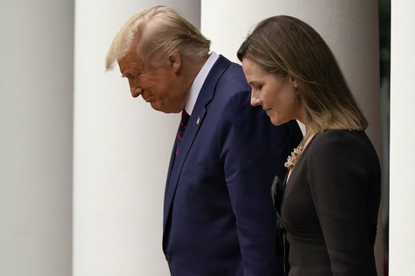 President Donald Trump walks with Judge Amy Coney Barrett to a news conference to announce Barrett as his nominee to the Supreme Court.