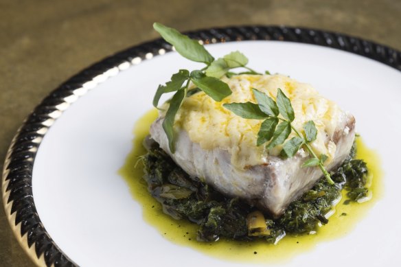 Hapuka fillet served with bitter greens and buttery leek chimichurri.