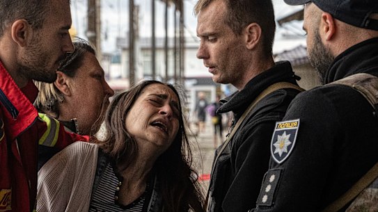 A woman, Sabina, cries after her husband Artem Pogorelets was killed by Russian shelling at Barabashovo market in Kharkiv, Ukraine, on Thursday, July 21.