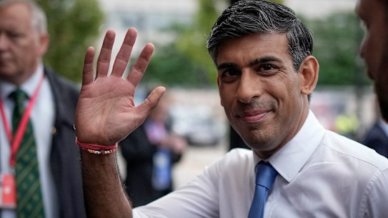 British Prime Minister Rishi Sunak walks to his hotel on the first day of the Conservative Part Conference at Manchester Central in Manchester.