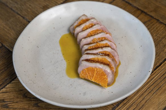 Slices of rosy Wimmera duck breast are interleaved with mandarin segments.