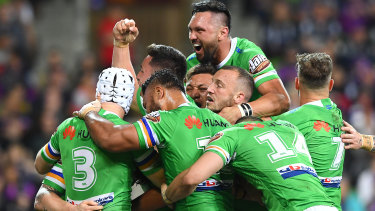 Bogey team: Canberra celebrate Bateman's try and a second victory over Melbourne this year.