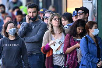 People queue outside Centrelink in Melbourne in March.
