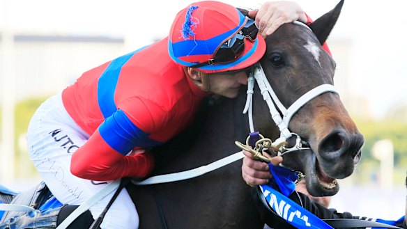 Jockey James McDonald kisses Verry Elleegant after winning the 2020 Winx Stakes.