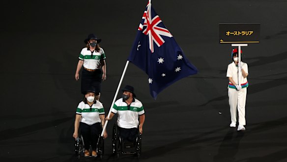 Dani Di Toro and Ryley Batt fly the Australian flag at the Paralympic Games opening ceremony. 