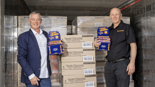 Richard Sims (left) and Phil Sims with the first shipment of 77,000 Violet Crumbles. 