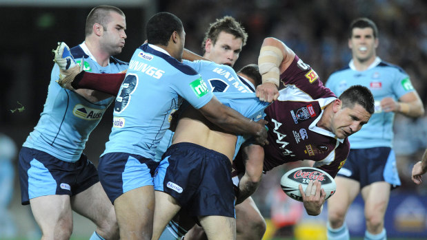 Team effort: Steve Price is tackled by a host of players in game three.