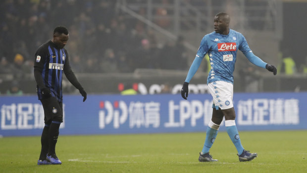 Napoli's Kalidou Koulibaly, right, leaves after receiving a red card after he was racially abused by fans.
