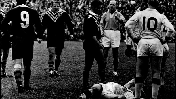 England second-rower Bill Ramsay lies unconscious after an altercation with Kelly (No.9) during a Test match in 1966.
