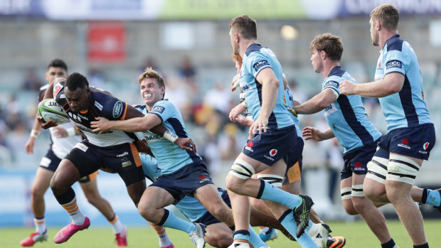Tevita Kuridrani of the Brumbies is tackled by NSW playmaker Will Harrison during round seven of Super Rugby, just before the season was suspended.