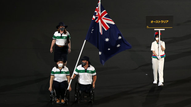 Dani Di Toro and Ryley Batt fly the Australian flag at the Paralympic Games opening ceremony. 