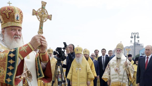 Russian Orthodox Church Patriarch Kirill, left, leads a religion service as Russian President Vladimir Putin, right, attends a ceremony marking the 1030th anniversary of the adoption of Christianity by Prince Vladimir, the leader of Kievan Rus, a loose federation of Slavic tribes that preceded the Russian state in Moscow, Russia.