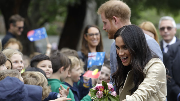 Britain's Prince Harry and Duchess of Sussex Meghan, greet children during a visit to Albert Park Primary School in Melbourne. 