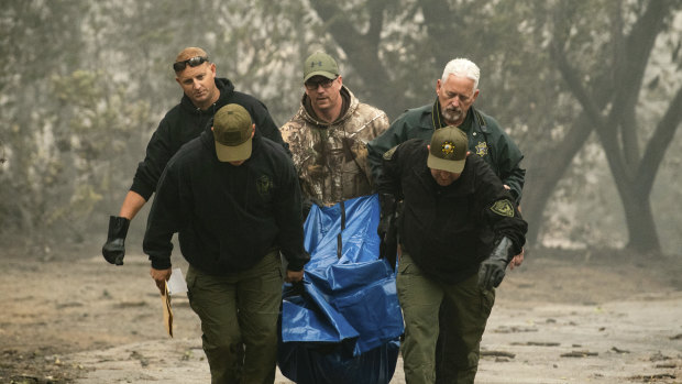 Sheriff's deputies recover the remains of a victim of the Camp Fire.