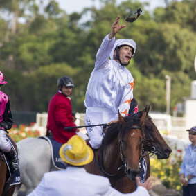 Hugh Bowman hurls his goggles to "the crowd after the Golden Slipper
