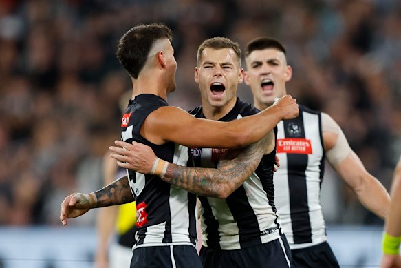 Jamie Elliott of the Magpies celebrates a goal with Nick Daicos.