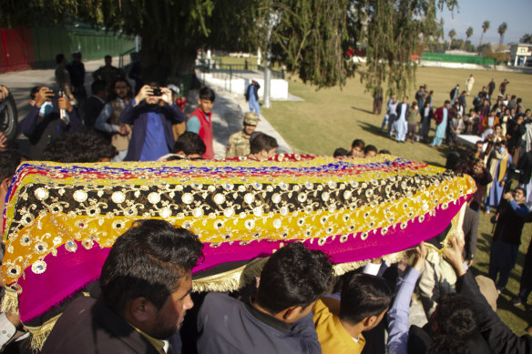 Relatives carry the body of journalist Malala Maiwand at her funeral. 