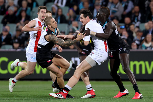 Hamish Hartlett and Aliir Aliir tackle Jake Carlisle 