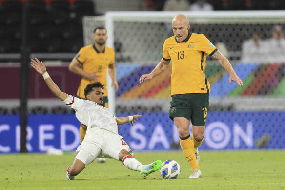 Abdullah Ramadan of United Arab Emirates and Australia’s Aaron Mooy fight for the ball.
