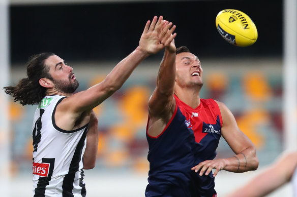Braydon Preuss battles in the ruck with Collingwood's Brodie Grundy.