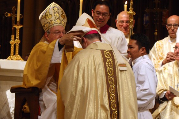 George Pell ordains Peter Comensoli as bishop in 2011.