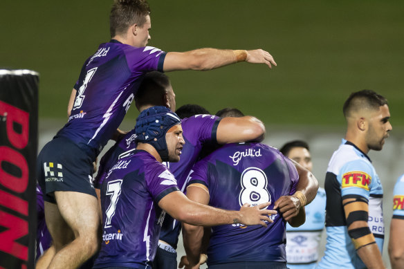 Melbourne Storm celebrate after Tui Kamikamica's try.