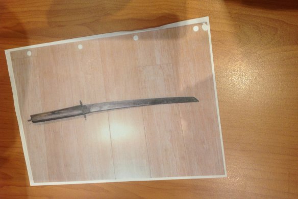 The sword police allege Stephen Macras held up at officers.