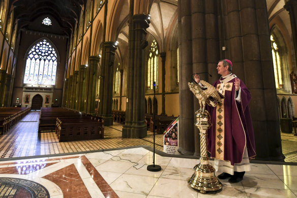 Archbishop Comensoli delivers the homily to empty pews as a result of COVID-19 restrictions earlier this year.