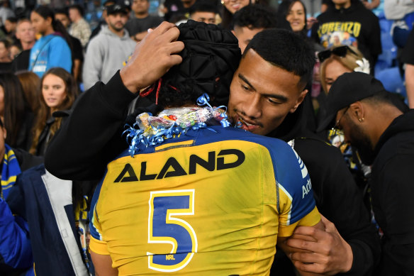 Twins Lorenzo and Ronaldo Mulitalo hug after Lorenzo made his debut for the Eels on Saturday night.