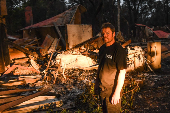 Russell Marriott in front of his burnt out home two days after the fire in Mallacoota.
