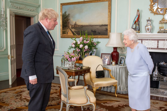 The Queen greets Prime Minister Boris Johnson in June at their first in-person weekly meeting since the start of the coronavirus pandemic.