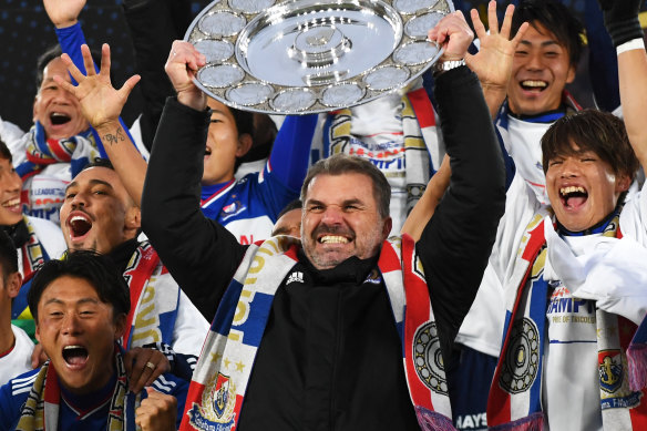 Ange Postecoglou raises the 2019 J-League trophy in triumph in Yokohama.