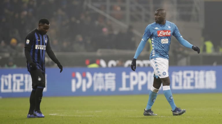 Napoli's Kalidou Koulibaly, right, leaves after receiving a red card, after he was racially abused at length by fans.