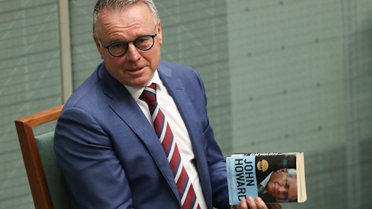 Labor MP Joel Fitzgibbon holds a copy of John Howard’s book ‘Lazarus Rising’ in Question Time.