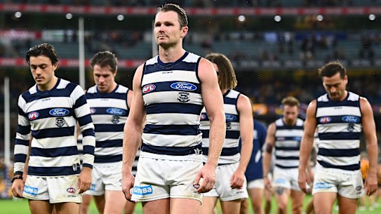 Patrick Dangerfield and the Cats leave the field after their loss to Hawthorn.