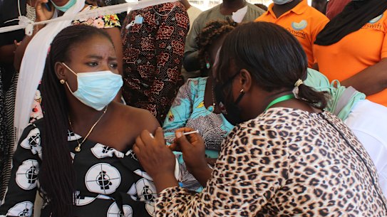 A Nigeria civil servant receives a dose of the AstraZeneca coronavirus vaccine.